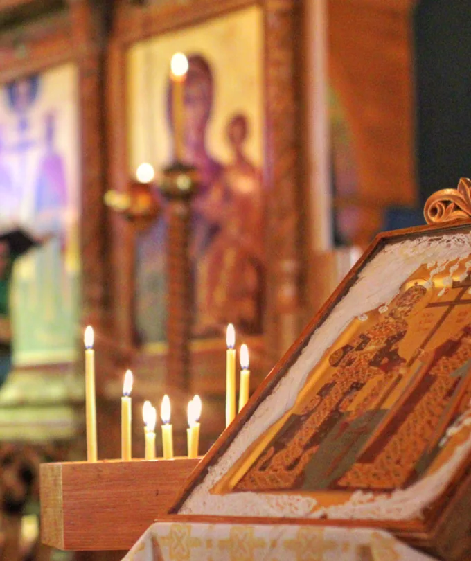 An icon and lit candles inside Saints Constantine & Elena