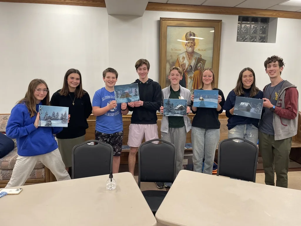 Parish youth displaying their winter landscape paintings